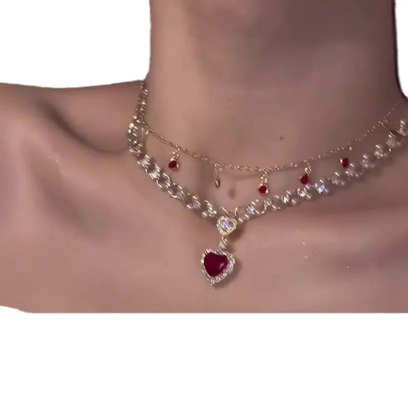 Red alloy double layer necklace with a love heart pendant on a regular chain.