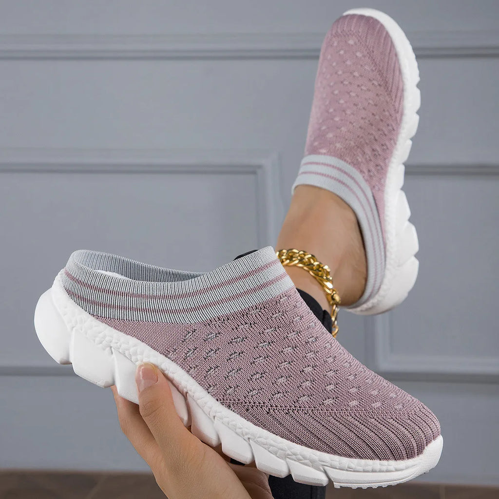 Women's black striped Flyknit slipper shoes with hollowed-out design on a viscose sole.