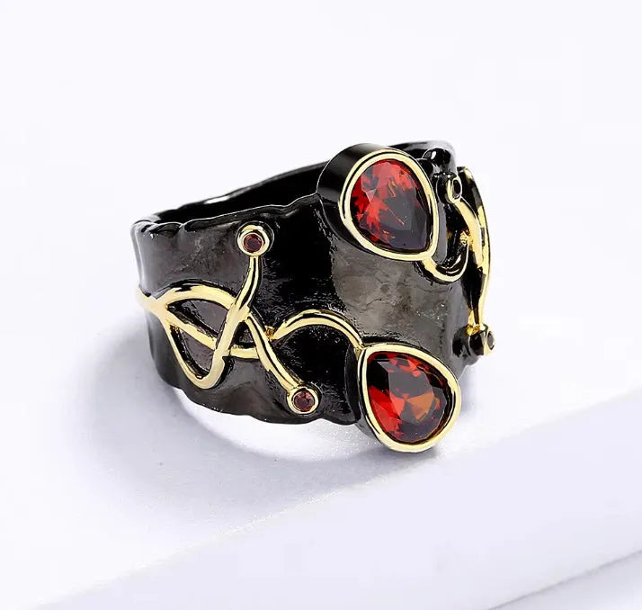 Retro women's straight-pull oval ring in brass with black finish, side view on light background