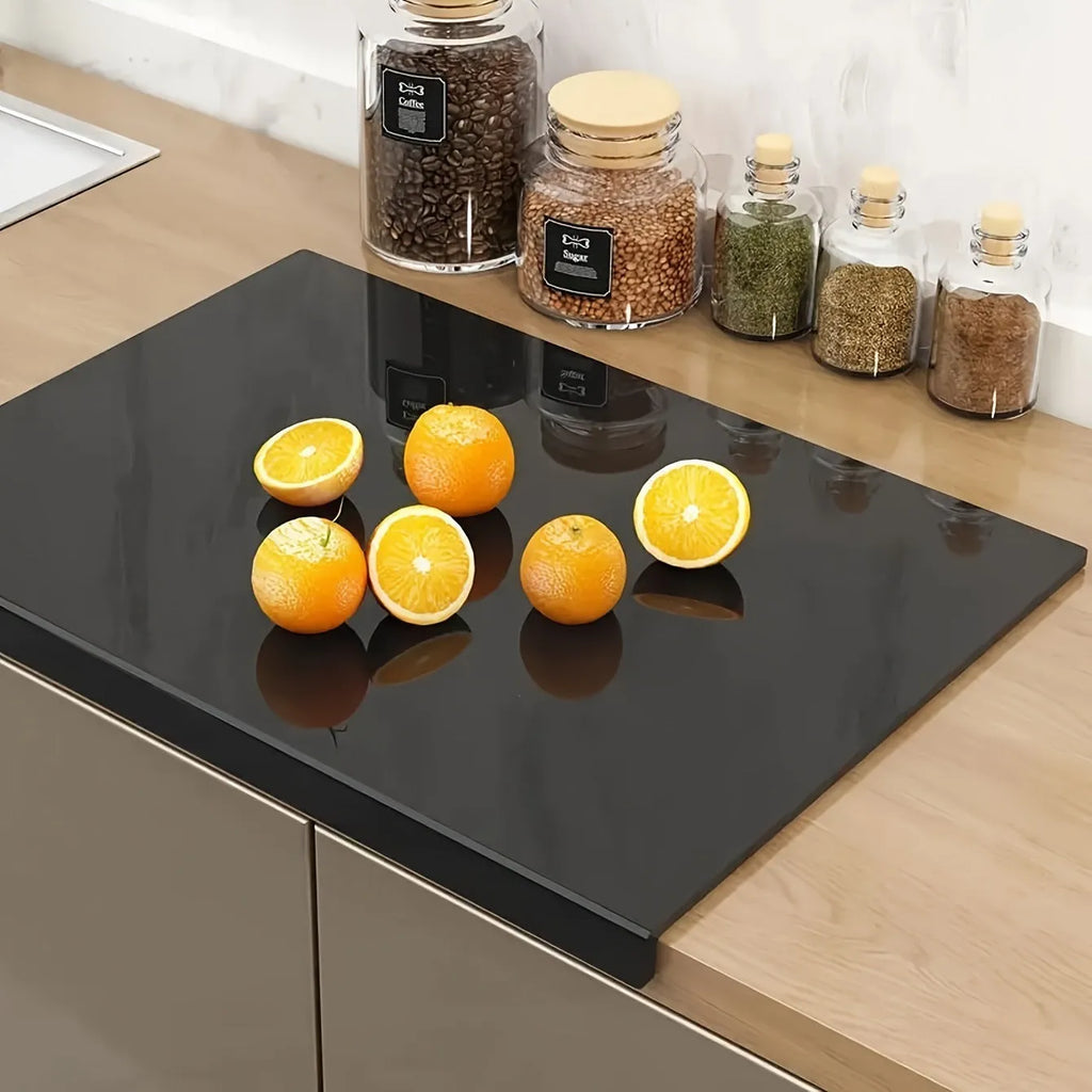 Black transparent acrylic chopping board in 30 x 20 cm size on a kitchen counter
