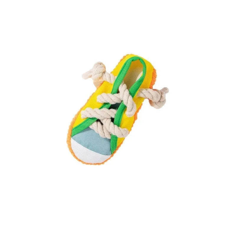 Plastic dog chew toy in slipper shape with sound feature, shown in yellow, black, and blue colour options.