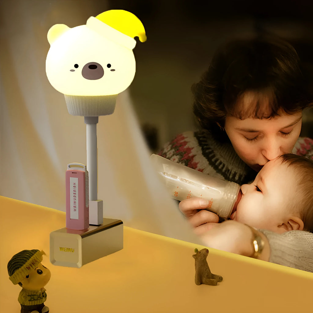 USB portable cartoon animal LED night light with remote control on a bedside table.