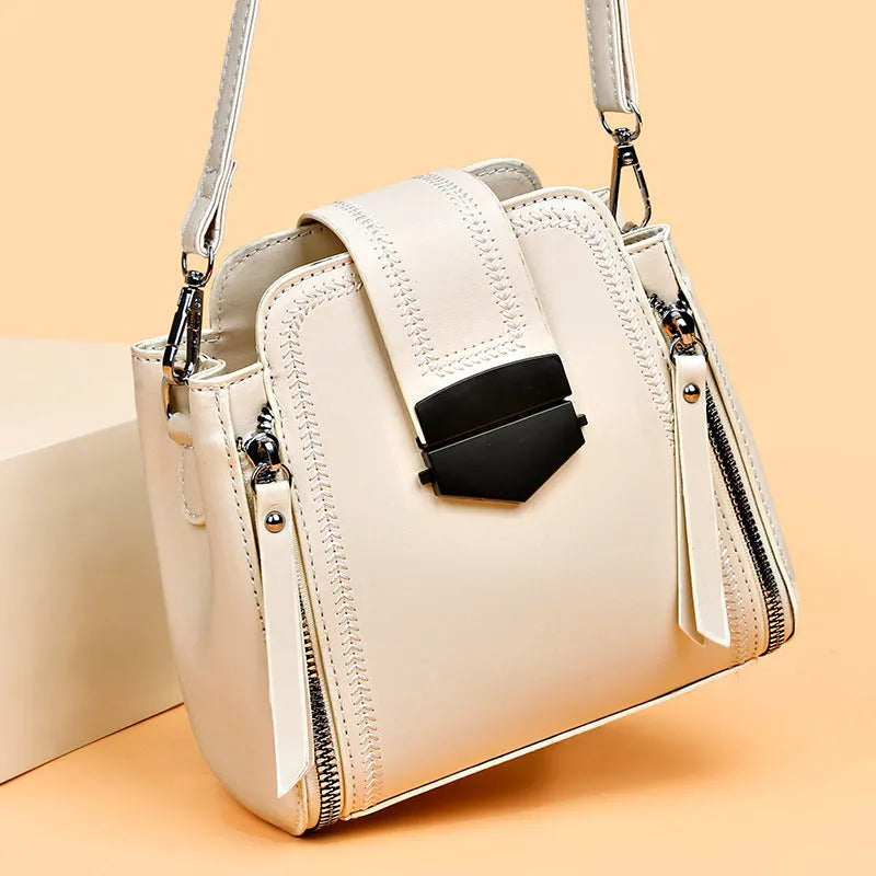 Soft textured PU leather ladies handbag in a square vertical shape with sewn thread detailing.