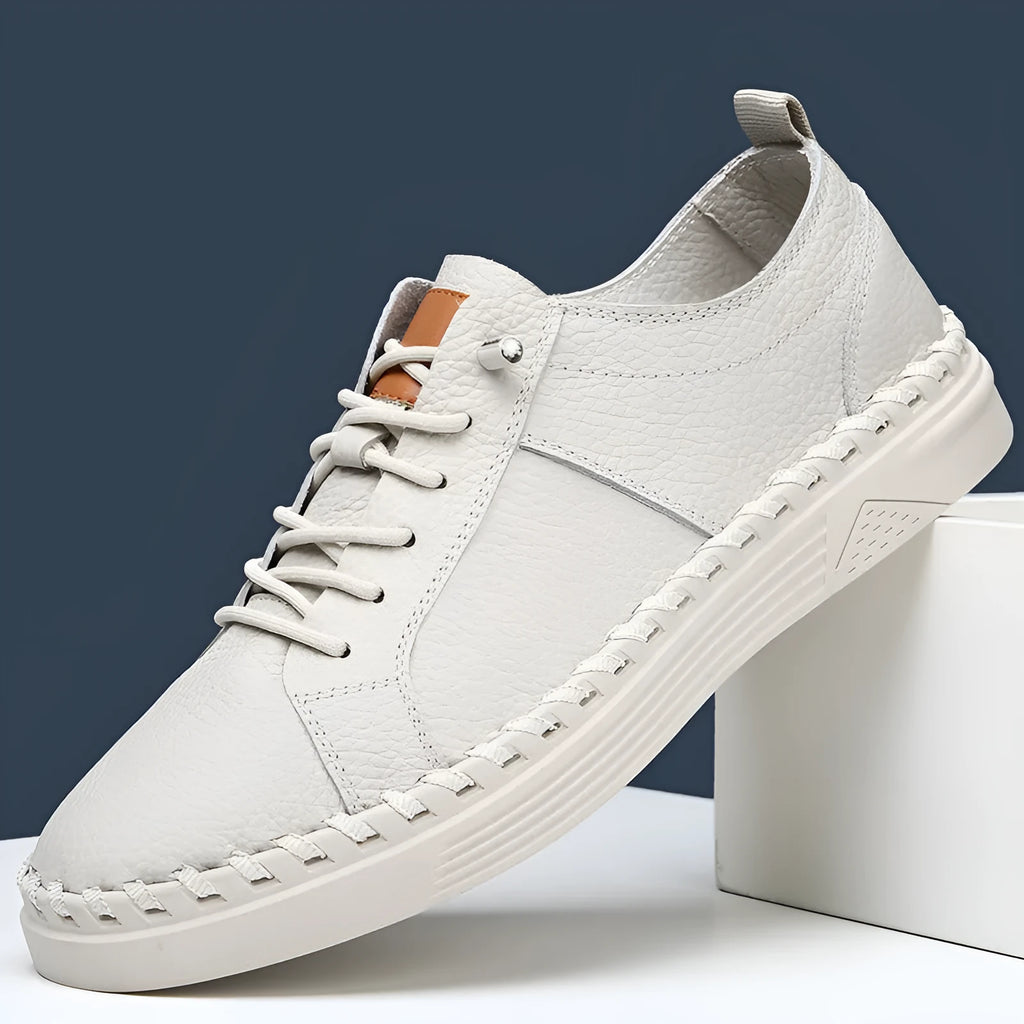 Men's beige casual leather sneakers with mesh lining and round toe stitching detail.
