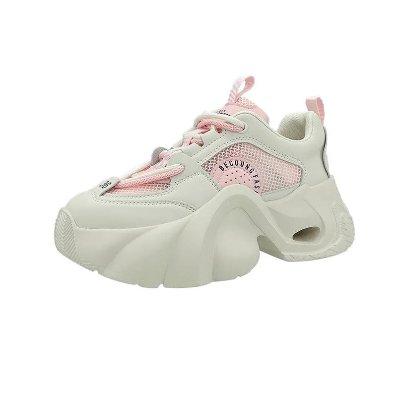 Women's pink sneakers with a thick sole, cross shoulder straps, and a mesh lining.