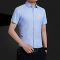 Men's non-iron short sleeve casual shirt in light blue, loose fit, cotton blend, front view