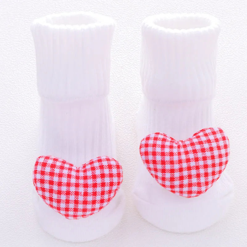Cotton baby socks with non-slip soles in multiple designs including bows, stars, and animal prints.