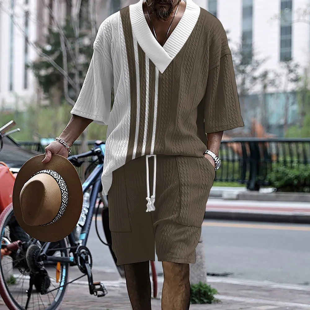 Man wearing a printed drop-shoulder knitted top and matching shorts from a casual summer suit.