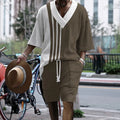 Man wearing a printed drop-shoulder knitted top and matching shorts from a casual summer suit.