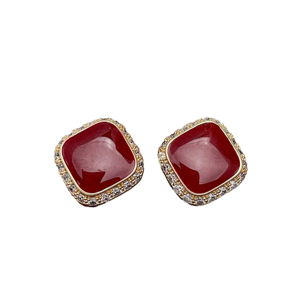 Red alloy square earrings with an inlaid geometric pattern, shown from the front.