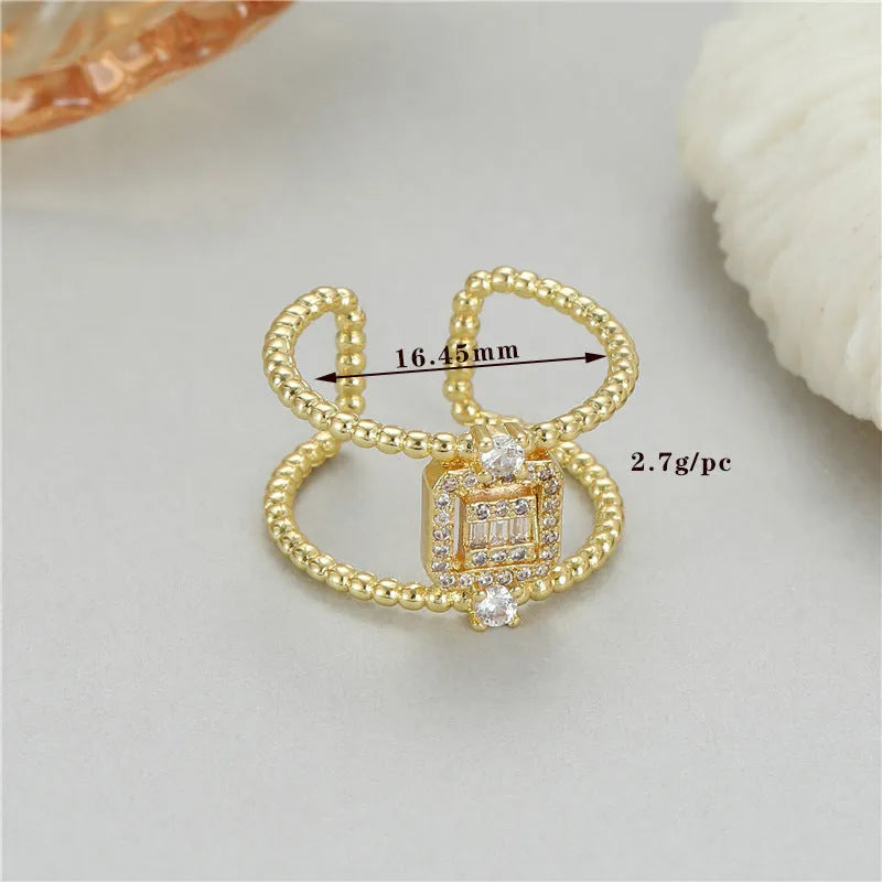 Gold-coloured adjustable open ring with an asymmetric U-shaped design on a white background.