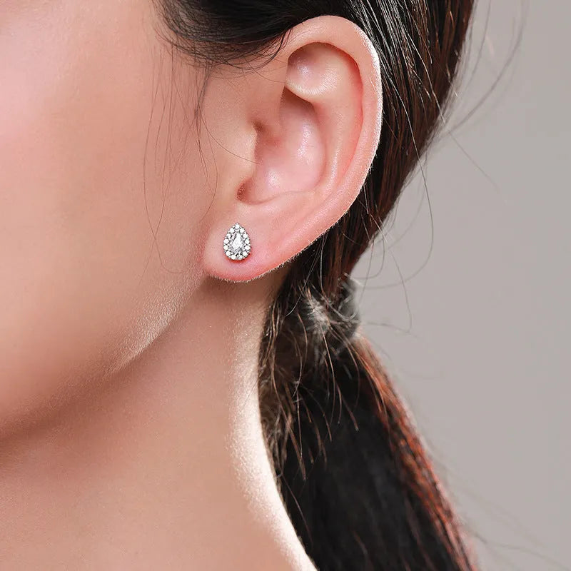 A pair of women's silver drop ear studs with a diamond-cut sparkling finish.