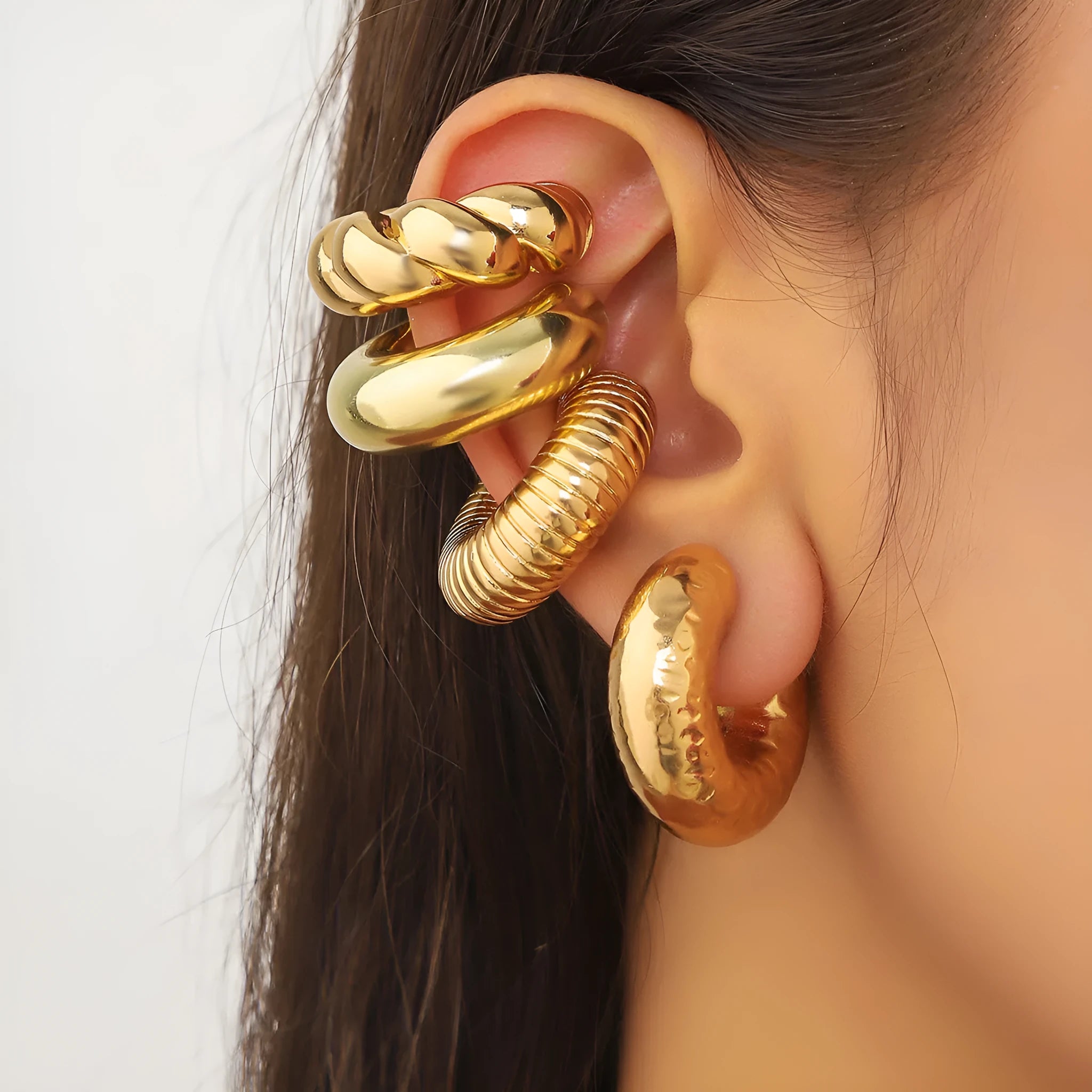 Set of four geometric clip-on earrings for women in gold and silver colours with exaggerated non-pierced design