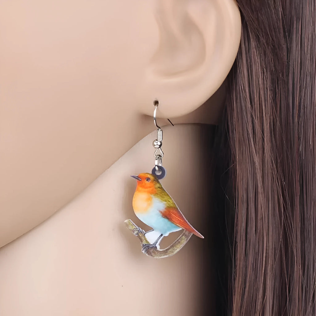 Acrylic geometric pendant earrings with a printed blue titmouse and snake chain design.