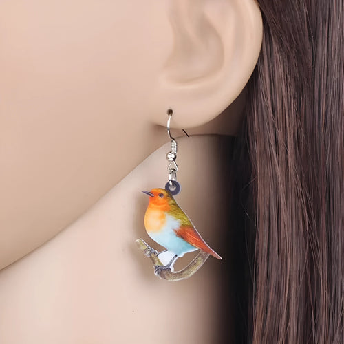 Acrylic geometric pendant earrings with a printed blue titmouse and snake chain design.