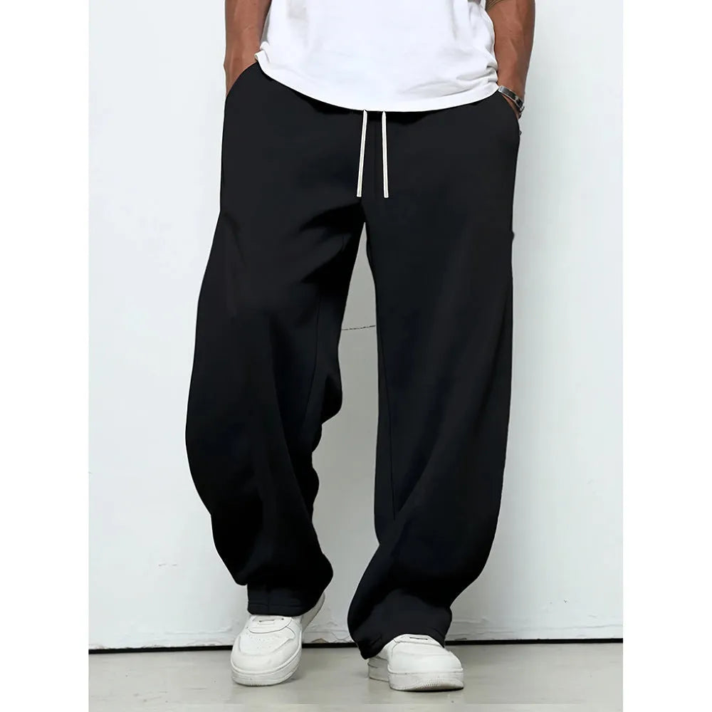 Man wearing grey micro-elastic casual trousers with a drawstring waist and straight leg.