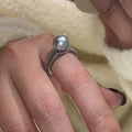 Adjustable open geometric copper ring for women with a small black pearl accent on the band.
