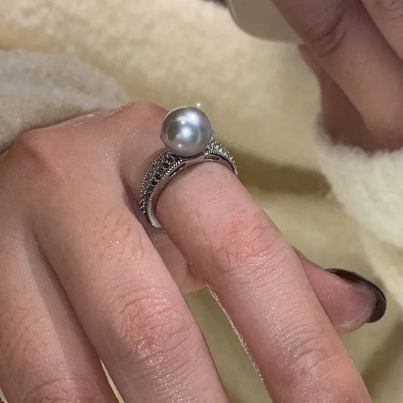 Adjustable open geometric copper ring for women with a small black pearl accent on the band.