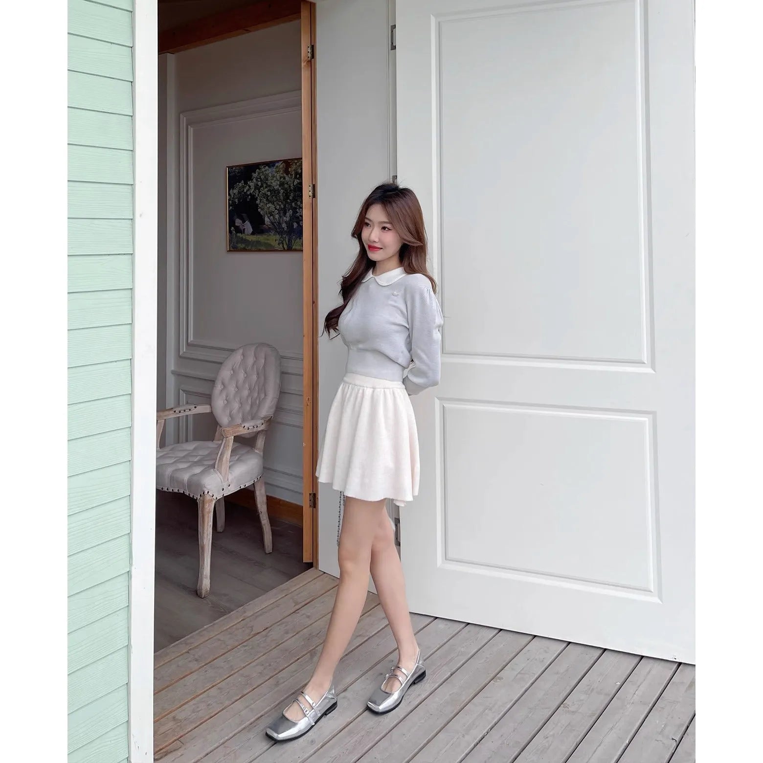 Women's silver leather ballet flats with a cross buckle strap and round toe.