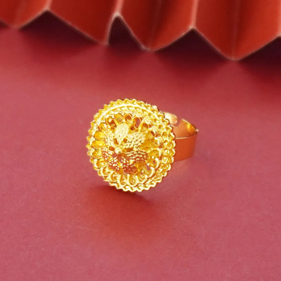 Gold-plated jewellery three-piece set with flower design pendant, matching earrings, and ring on display