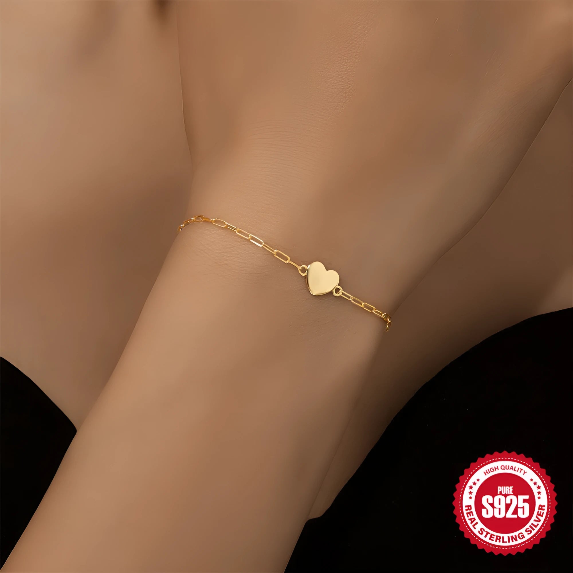 Gold tone S925 sterling silver bracelet with heart charm and clip chain closure