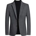 Men's slim fit wool suit jacket in grey, shown on a model, suitable for autumn and winter.