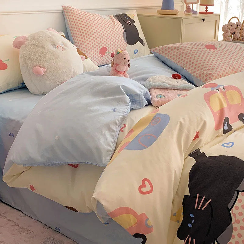 Cartoon dog print pure cotton four-piece duvet cover and bed sheet set on a bed.