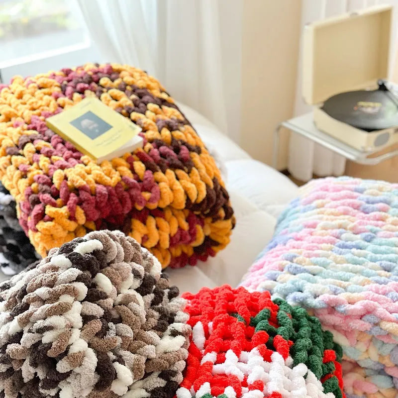 Handmade thick chenille striped blanket in a choice of four colours on a bed.