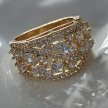 Women's round hollow ring with a gemstone, shown in gold and platinum with blue and white stone options.