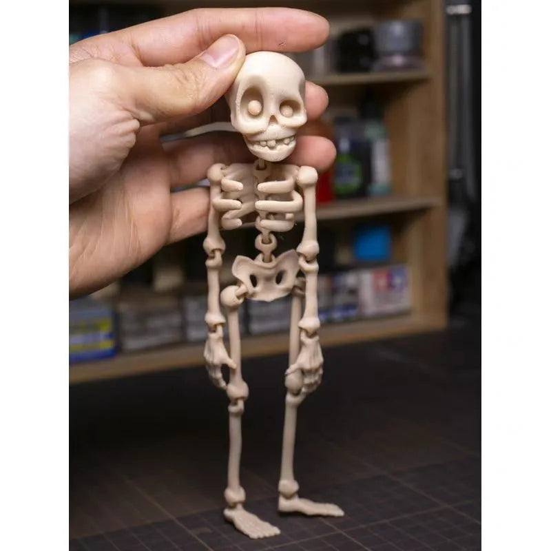 Tall 3D printed white skull ornament with intricate detail placed on a refrigerator door.