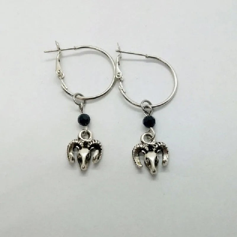 A pair of silver-coloured alloy round ring earrings for women with a Tibetan antelope design influence.