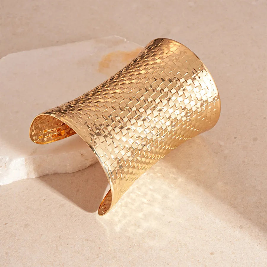 Women's vintage exaggerated metal bracelet in gold or silver colour with round design elements.