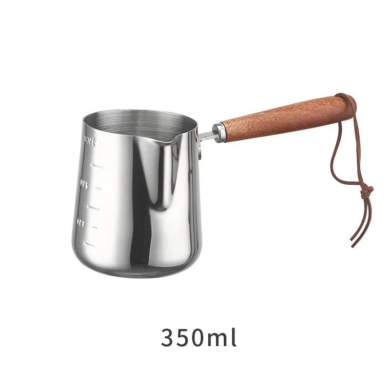 Stainless steel latte art milk frothing jug with measurement scale and wooden handle
