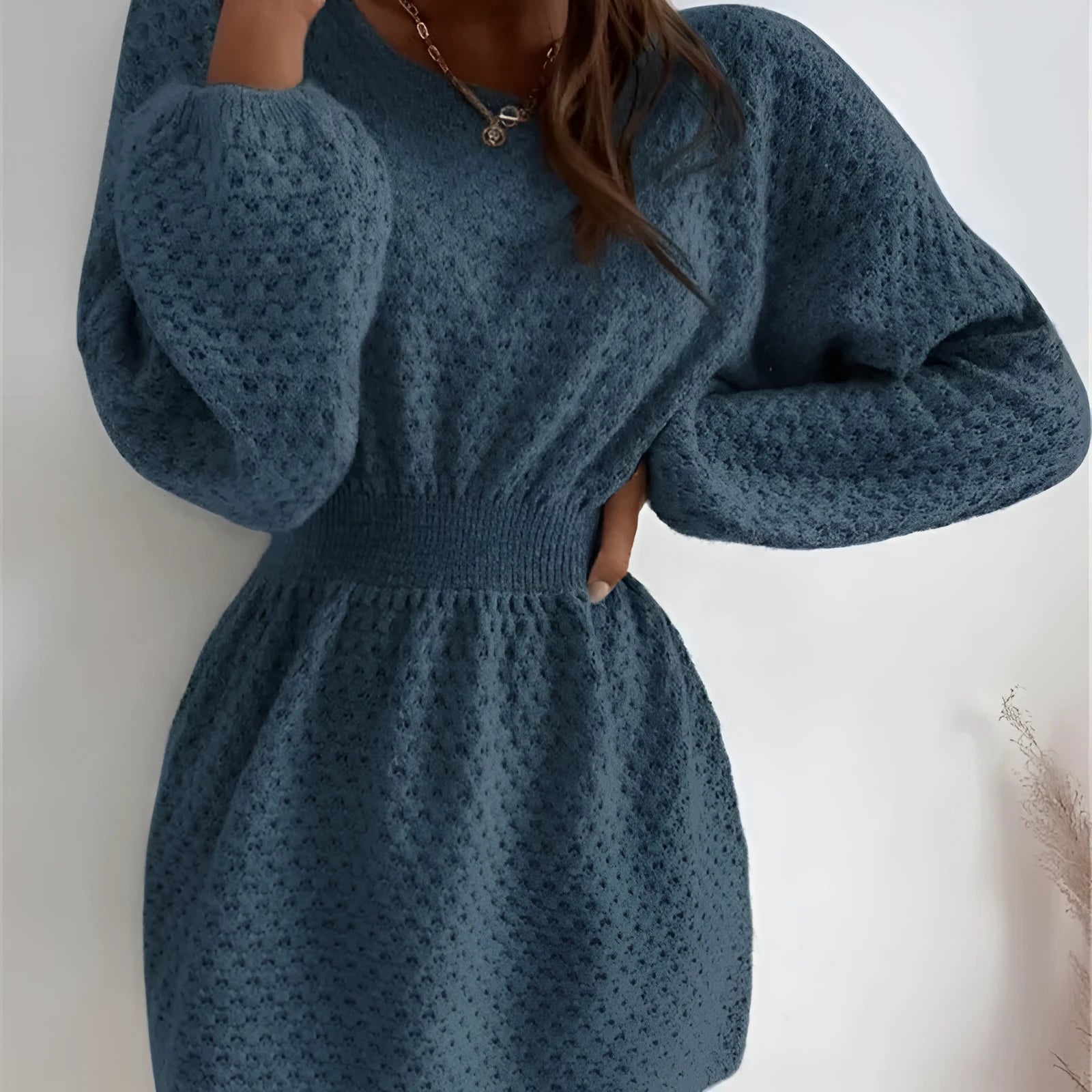 Blue women's knitted dress with fitted waist, crocheted flower details, and French round neckline