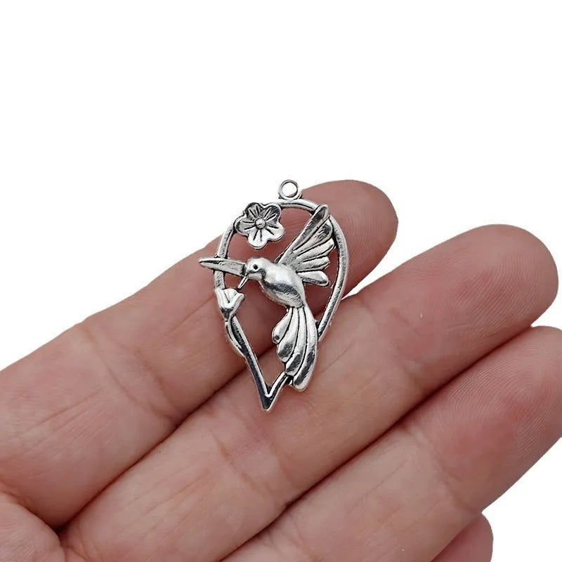 Alloy flying magpie bird pendant with electroplated finish in colour P234 for DIY jewellery.