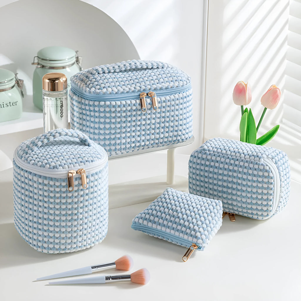 Four cube-style flannelette makeup bags in a set, shown in blue with dots colour.
