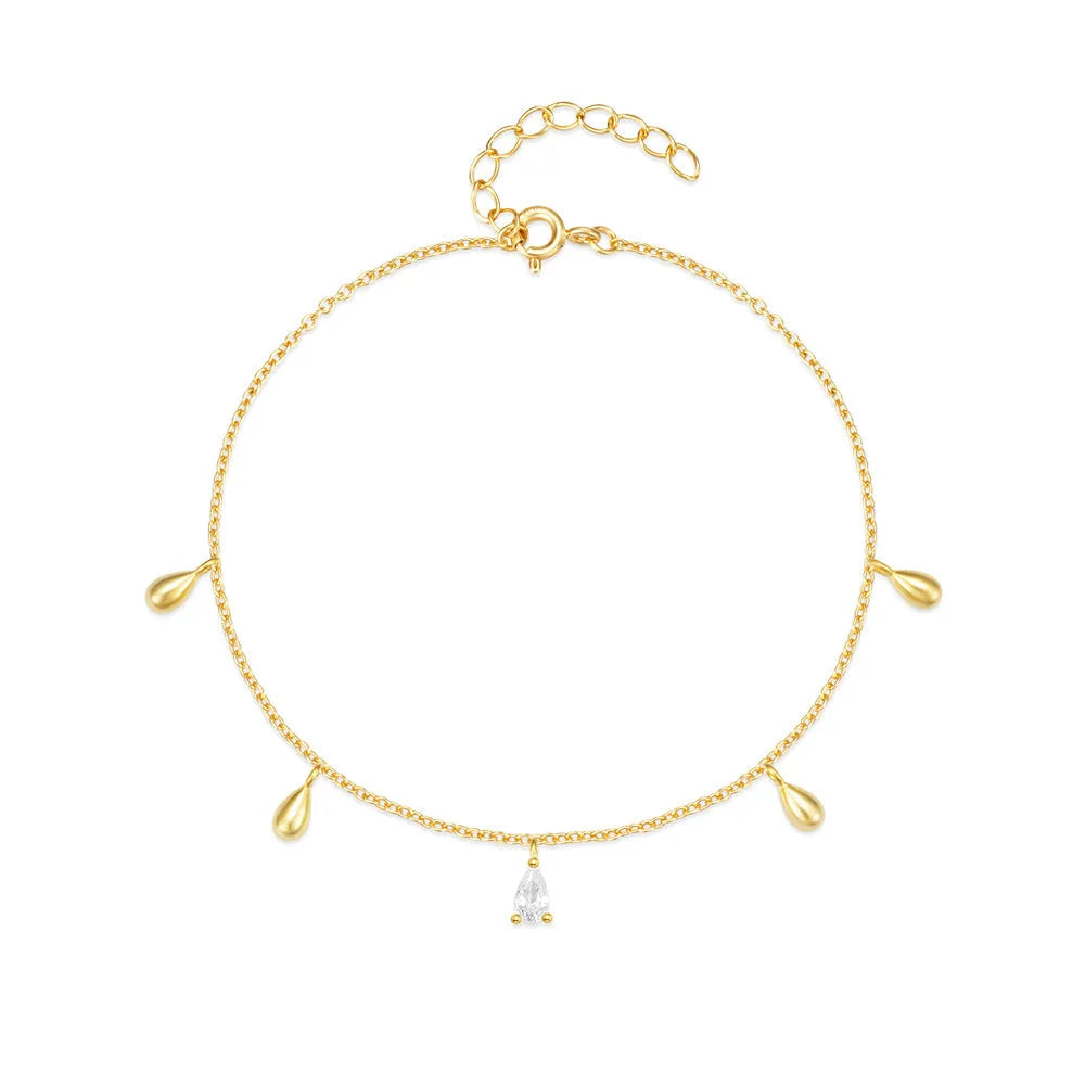 Gold plated sterling silver bracelet with a water droplet shaped diamond pendant on a woman's wrist
