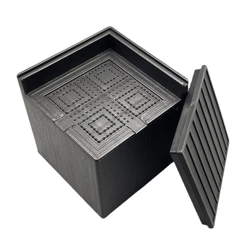 Four black plastic bed foot mats for furniture height adjustment and floor protection