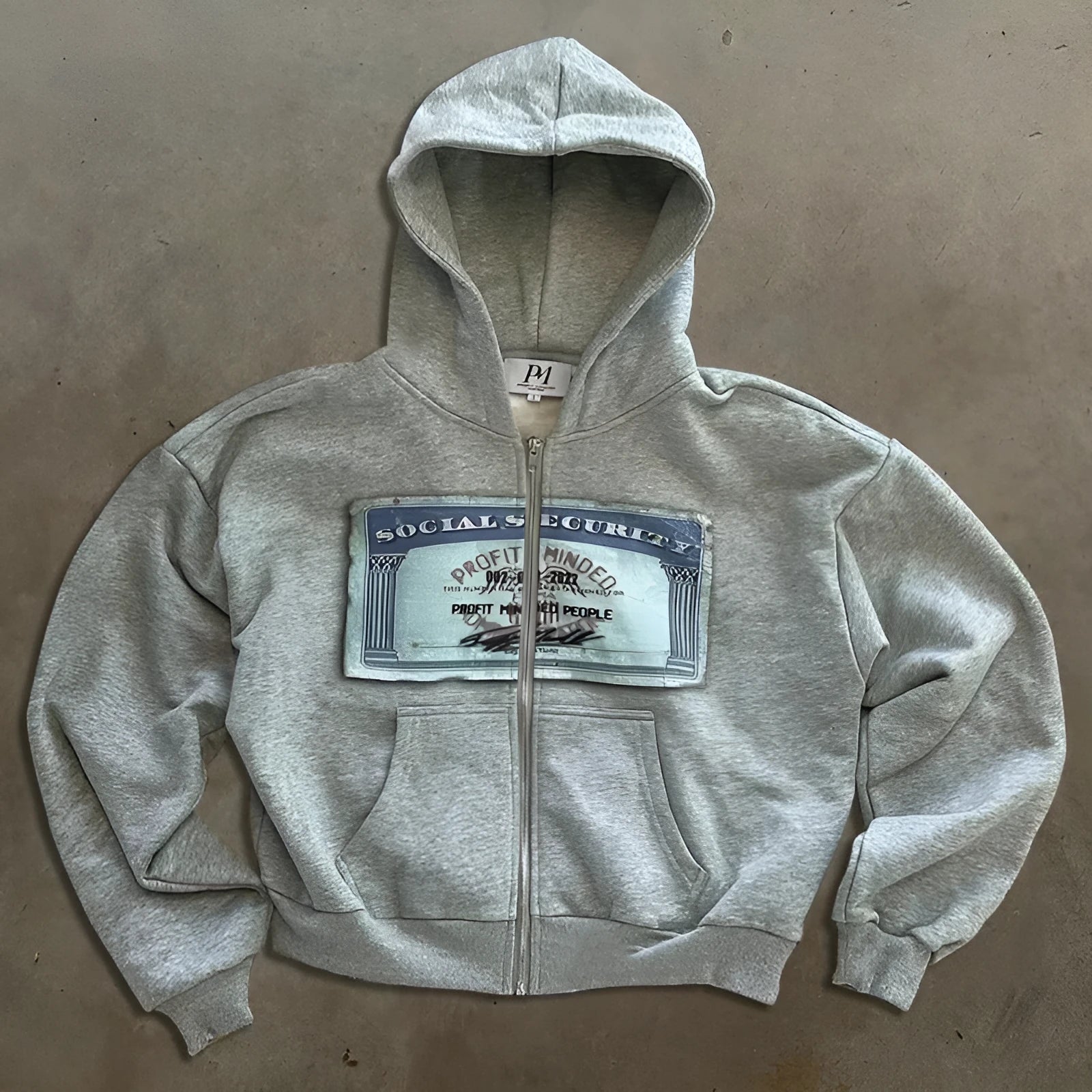 Unisex loose fit hoodie jacket with zipper pockets in black, grey, and pink colour options showing letter pattern detailing
