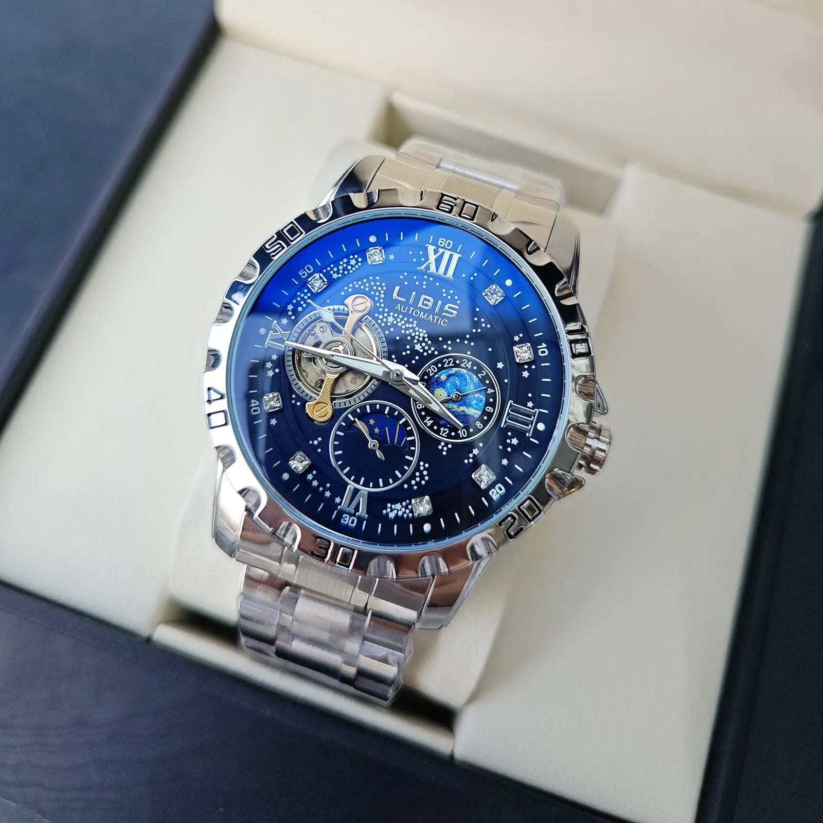 Men's silver case automatic watch with black steel strap and luminous dial.