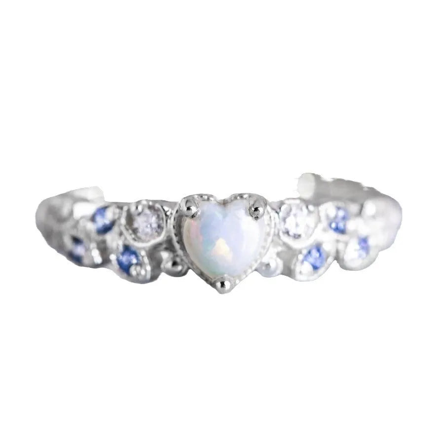 White electroplated alloy women's ring in a peach heart shape with flower and opal ocean design details.