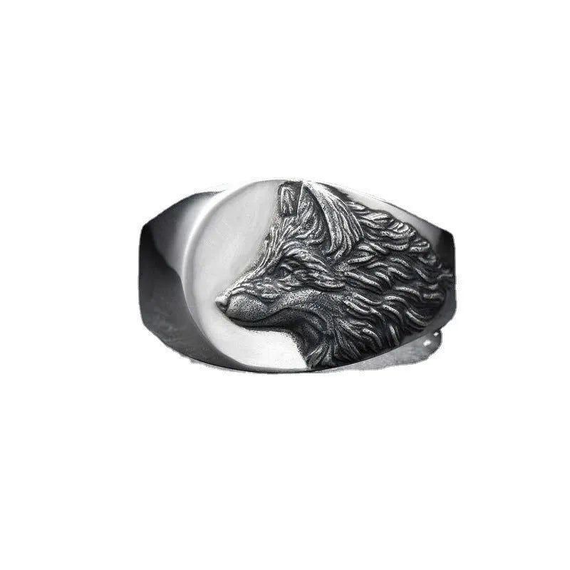 Men's silver geometric wolf head signet ring on a black background, showing its retro-inspired alloy design.