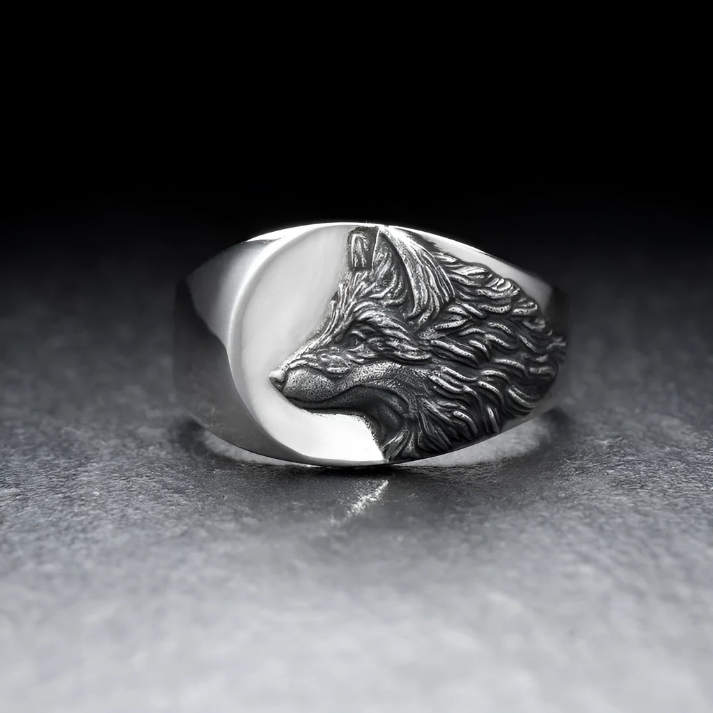 Men's silver geometric wolf head signet ring on a black background, showing its retro-inspired alloy design.