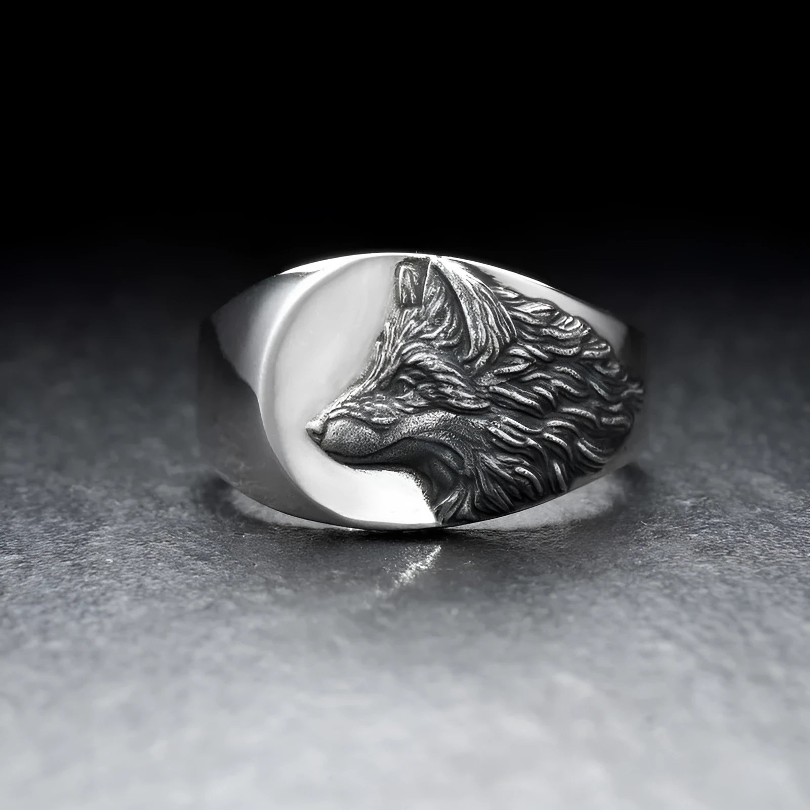 Men's silver geometric wolf head signet ring on a black background, showing its retro-inspired alloy design.
