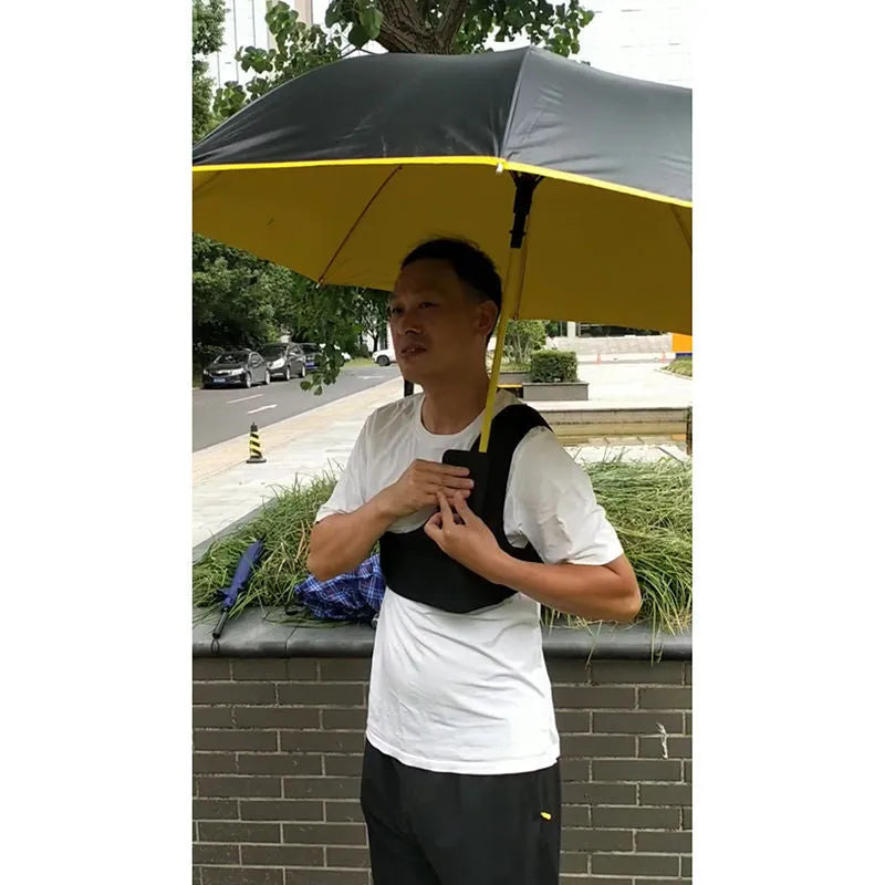 Black portable umbrella shoulder strap holder supporting an open manual folding umbrella.