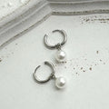 Women's geometric pearl earrings with round elements and titanium steel alloy construction