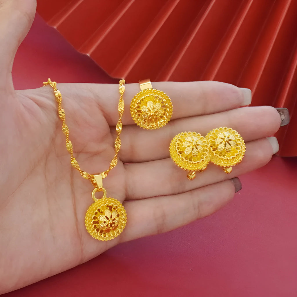 Gold-plated jewellery three-piece set with flower design pendant, matching earrings, and ring on display