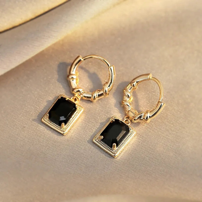 Pair of black geometric French court earrings with zircon stones on copper.