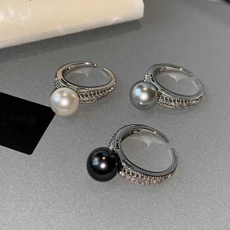 Adjustable open geometric copper ring for women with a small black pearl accent on the band.