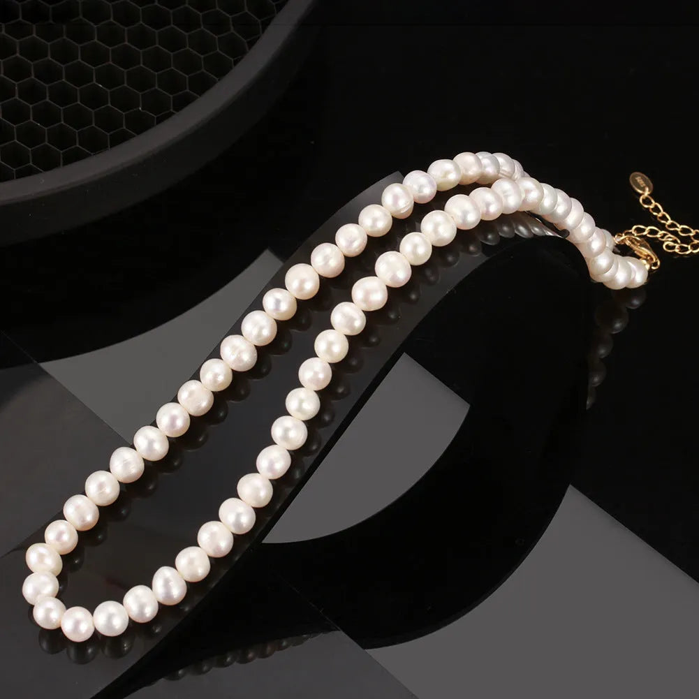 Women's adjustable silver necklace with a strand of natural freshwater pearls.